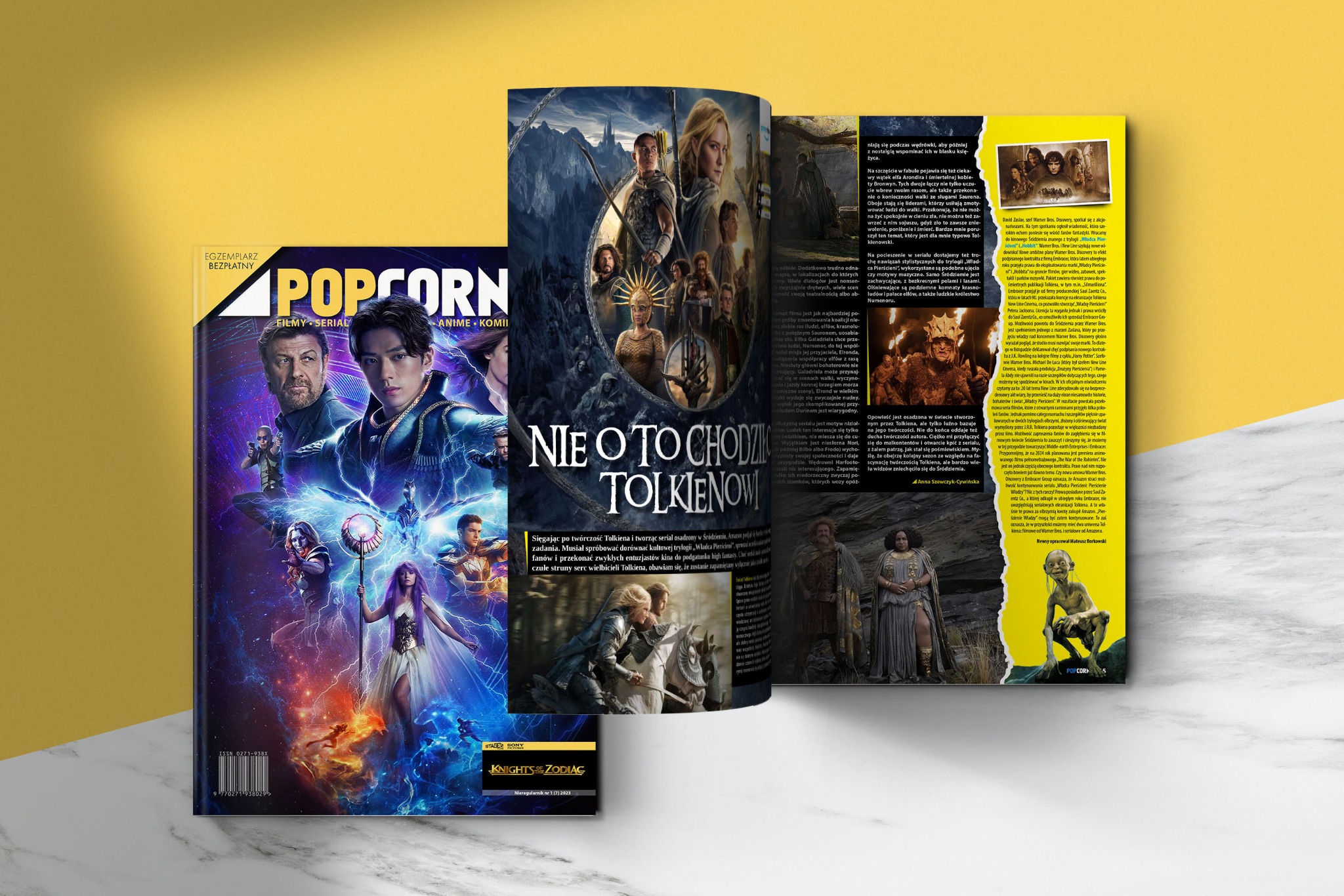 Rozłożony magazyn POPCORNER z okładką 'Knights of Zodiac' i artykułem o 'Władcy Pierścieni'. Widoczne kadry z filmów i seriali, tytuł 'Nie o to chodzi Tolkienowi'.