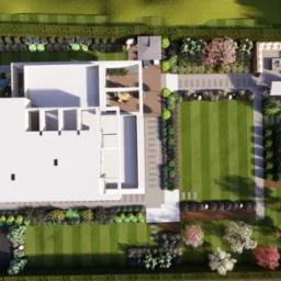 Widok z góry na wizualizację ogrodu z nowoczesnym domem, równo przyciętym trawnikiem, ścieżkami z kamienia i bogatą roślinnością. Projekt uwzględnia strefę relaksu.