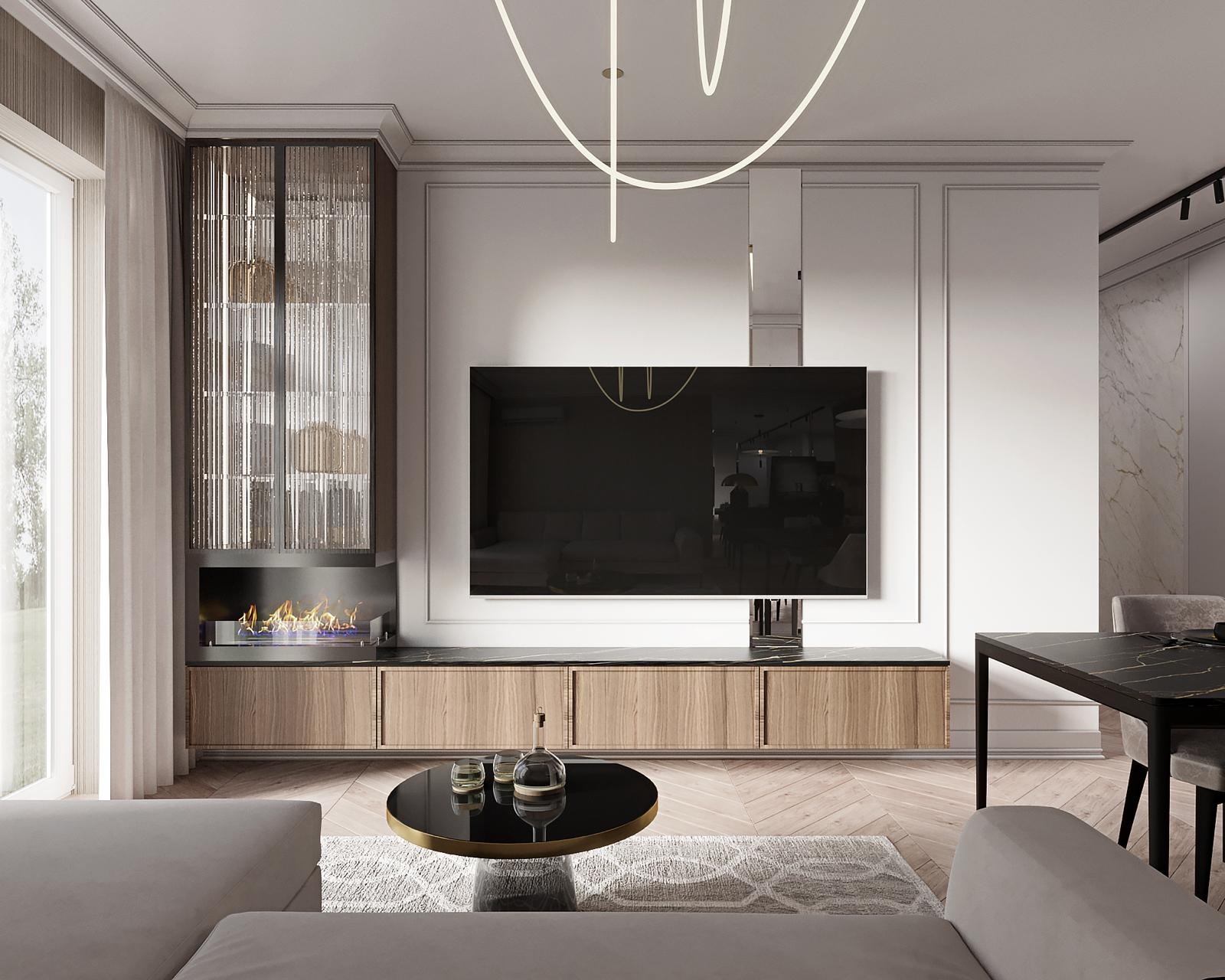 Nowoczesny salon z szafką RTV z forniru, wiszącym telewizorem i biokominkiem w zabudowie. Nad całością designerska lampa. Widoczny fragment sofy i stolika kawowego.