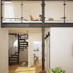 Dwupoziomowe wnętrze z antresolą, spiralnymi schodami i przesuwnymi drzwiami stodołowymi. Widoczny drewniany stół z kwiatami i dekoracje.