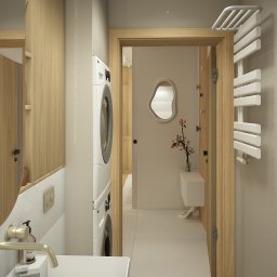 Space Creations - Studio projektowe Katarzyna Tajduś-Bzymek - Nowoczesna łazienka z pralką w zabudowie, umywalką nablatową i lustrem o nieregularnym kształcie. Jasne kolory, drewniane akcenty i minimalistyczny design.