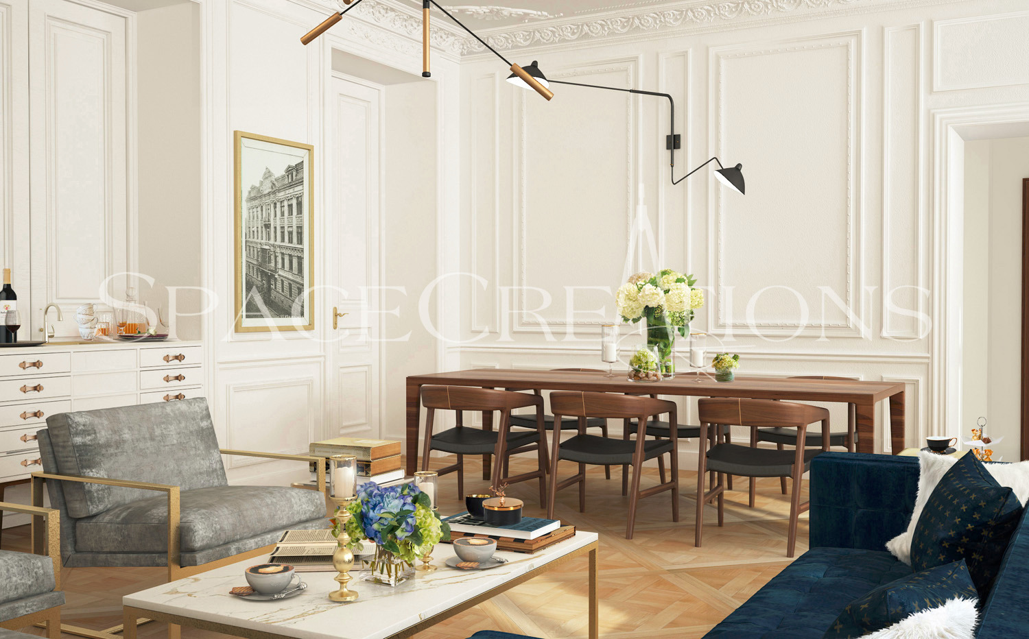 Eleganckie wnętrze: kremowe ściany z dekoracyjnymi listwami, drewniany stół z krzesłami, szary fotel i niebieska sofa. Całość oświetlona nowoczesną lampą.