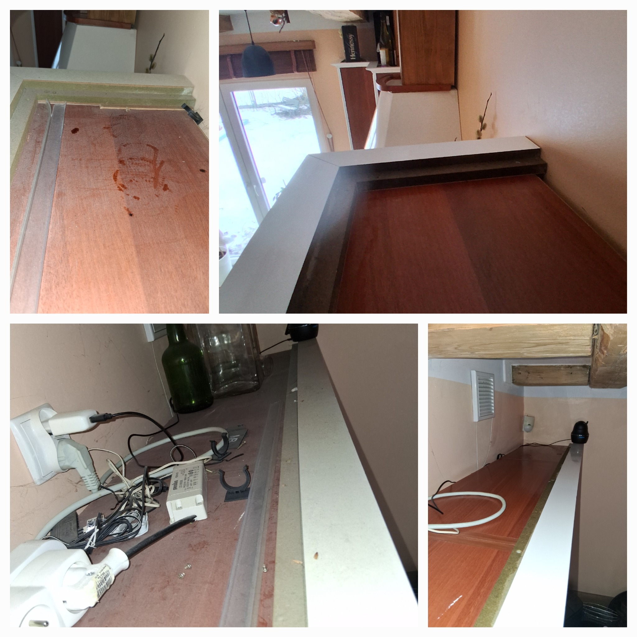 Brudna, drewniana powierzchnia blatu z plamami i kurzem, widoczne kable, gniazdka i butelki w tle. Niefachowe wykończenie, brak dbałości o detale.