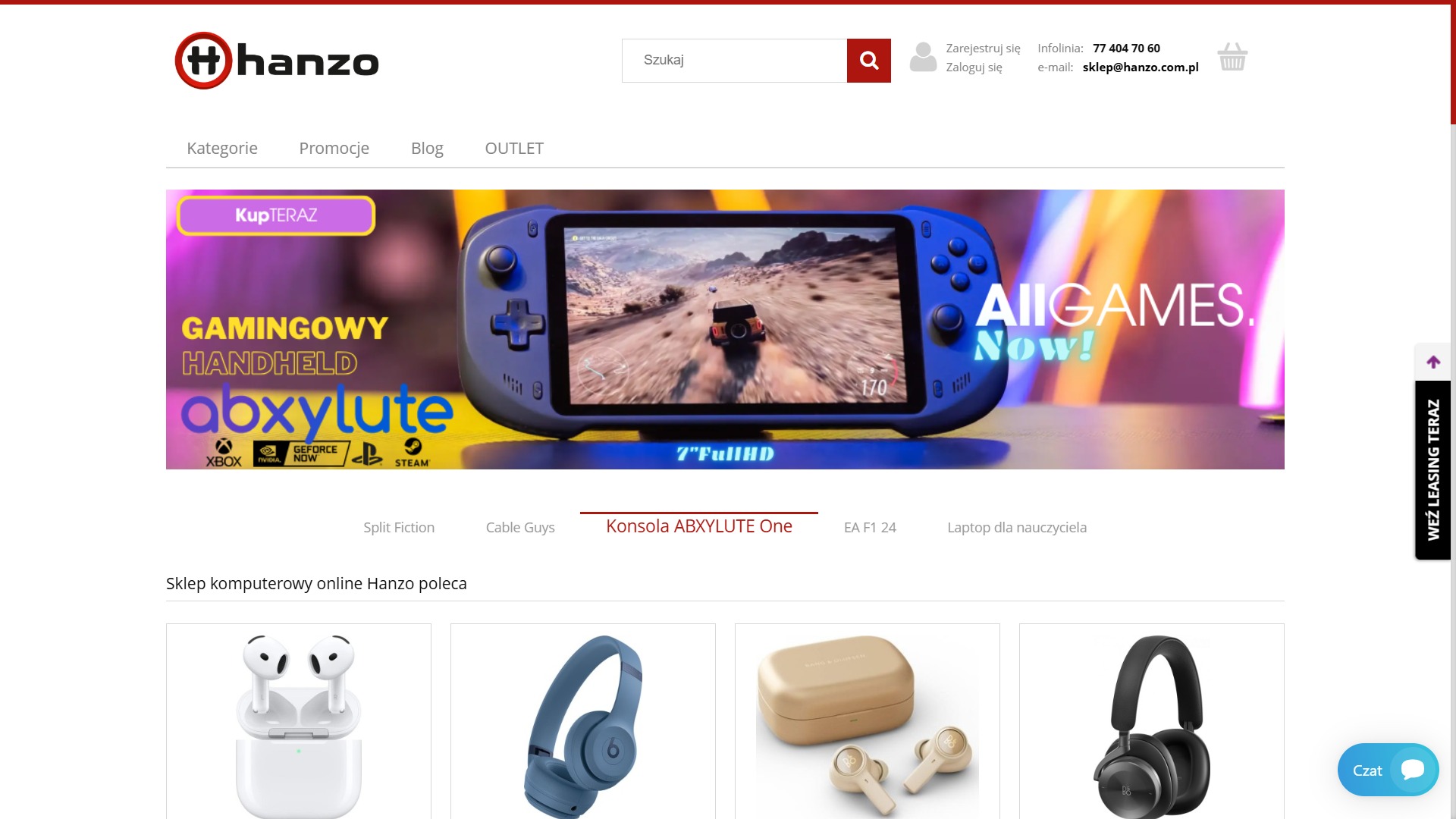 Strona internetowa sklepu Hanzo z gamingowym handheldem Abxylute One na banerze, obok promocyjne słuchawki. Widoczne logo Hanzo i menu nawigacyjne.