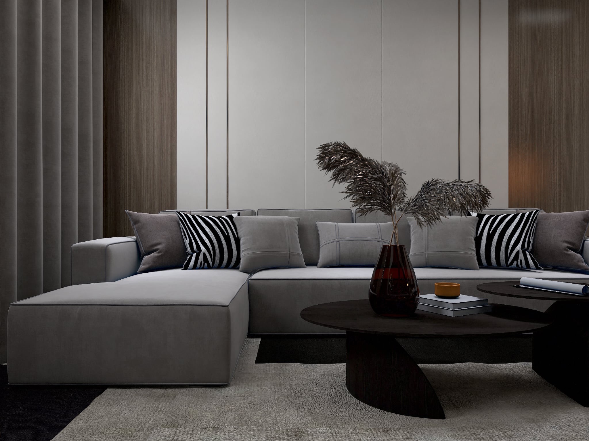 Stylowy, szary narożnik z poduszkami w salonie. Na stoliku wazon z dekoracyjną trawą. Minimalistyczne wnętrze z akcentami drewna i stonowaną kolorystyką.