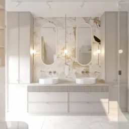 Jasna łazienka z marmurowymi płytkami, owalnymi lustrami i umywalkami nablatowymi. Minimalistyczne szafki i oświetlenie punktowe tworzą elegancki wystrój.
