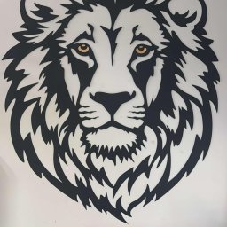 Profesjonalne cięcie CNC - Czarna, metalowa dekoracja ścienna: głowa lwa z żółtymi oczami, umieszczona nad niebieskimi segregatorami. Wykonanie CNC.