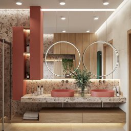 TRENDY Jacek Wasążnik - Nowoczesna łazienka z dwoma okrągłymi lustrami, umywalkami w kolorze terakoty i blatem z kamienia. Ściany wykończone płytkami imitującymi kamień, drewniane akcenty.