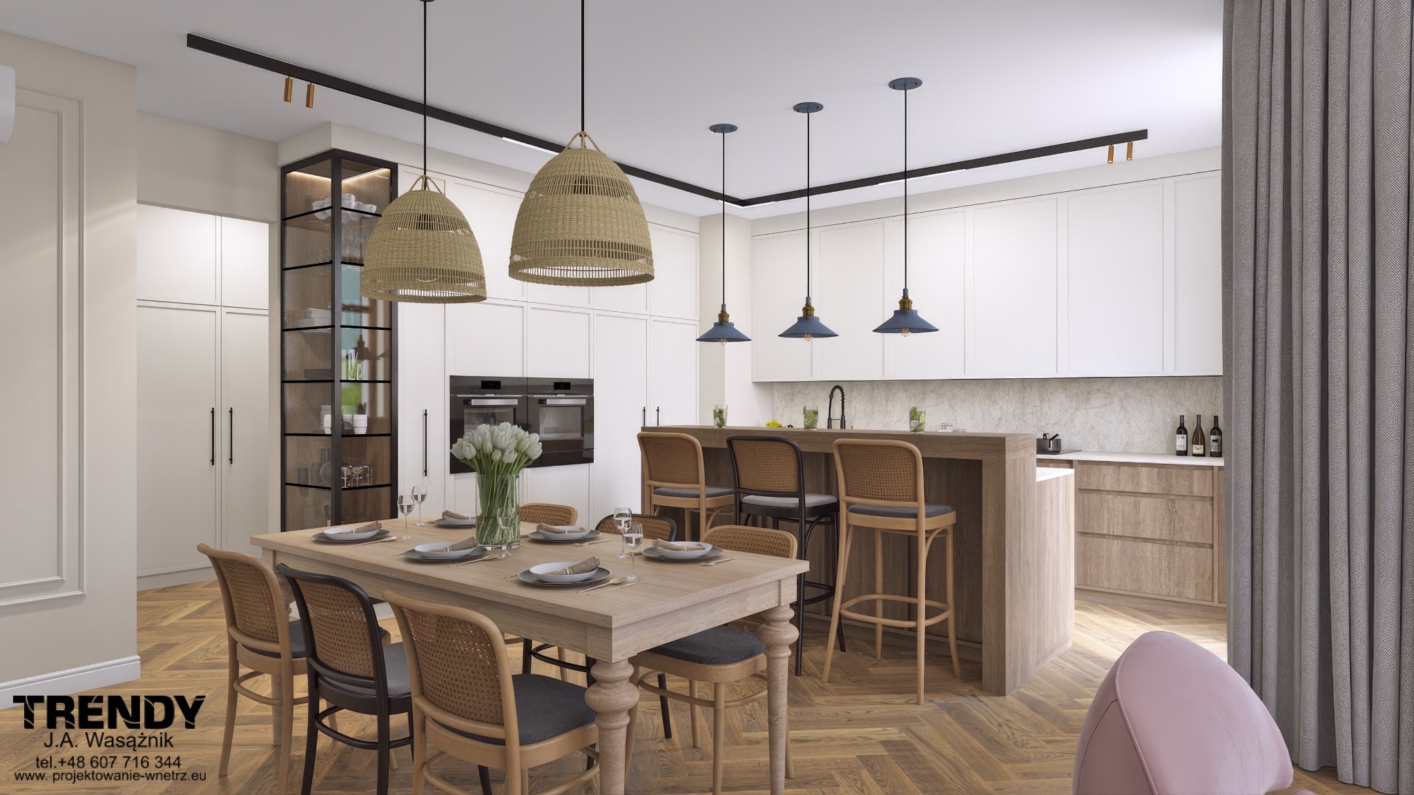 Elegancka, jasna kuchnia z wyspą i stołem jadalnym. Wnętrze doświetlają wiszące lampy w stylu boho. Widoczny parkiet w jodełkę i szklana witryna.