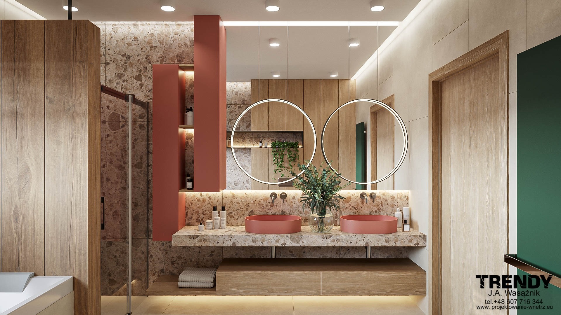 Nowoczesna łazienka z dwoma okrągłymi lustrami, umywalkami w kolorze terakoty i blatem z kamienia. Ściany wykończone płytkami imitującymi kamień, drewniane akcenty.