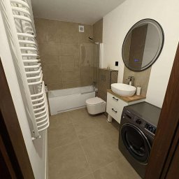 Nowoczesna łazienka w beżach: wanna z parawanem, umywalka na szafce z drewnianym blatem, okrągłe lustro i pralka. Grzejnik drabinkowy po lewej.