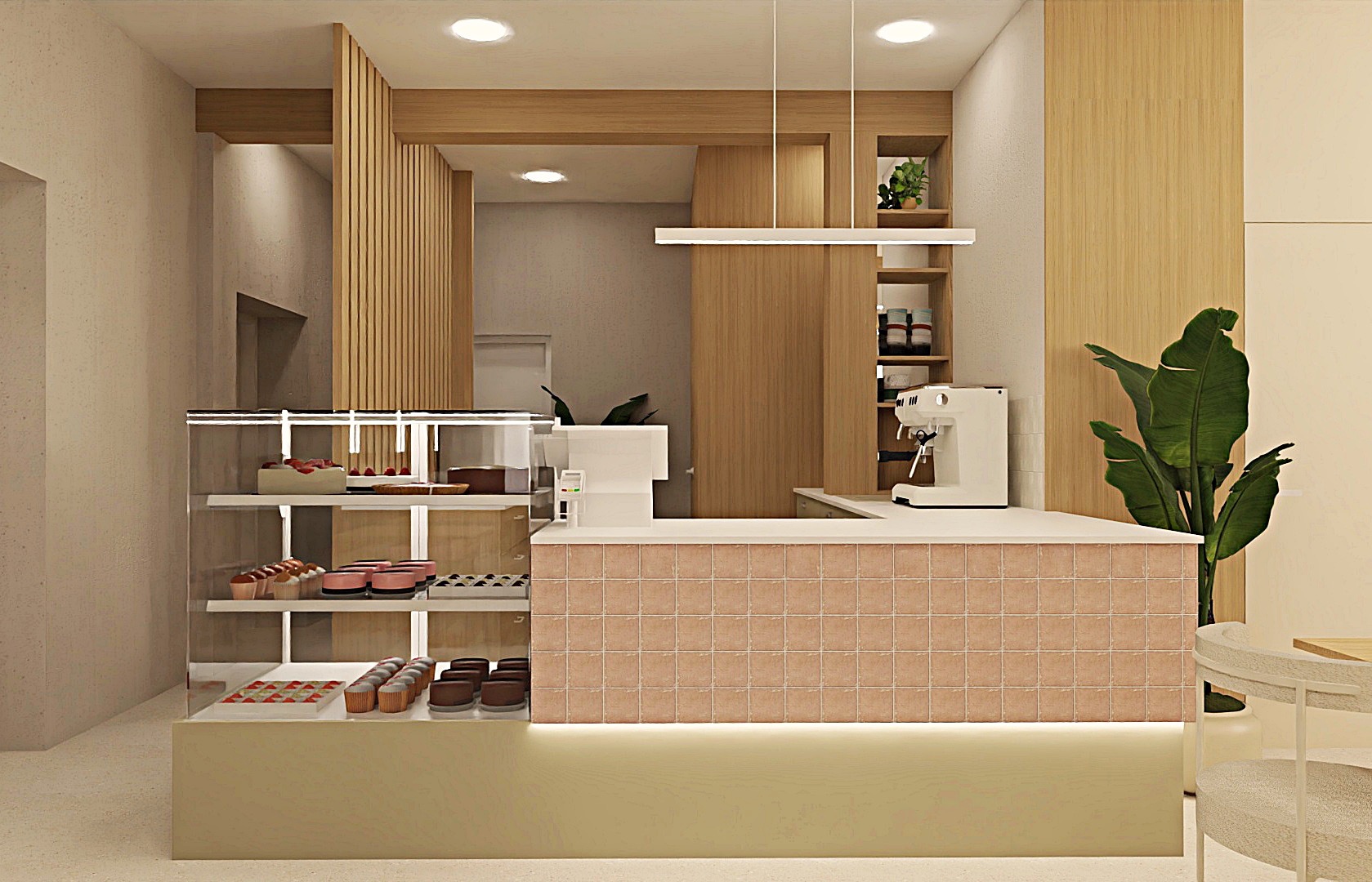 Wnętrze kawiarni z ladą wykończoną mozaiką, przeszkloną witryną z ciastami i ekspres do kawy. Elementy drewniane i rośliny doniczkowe dopełniają aranżację.