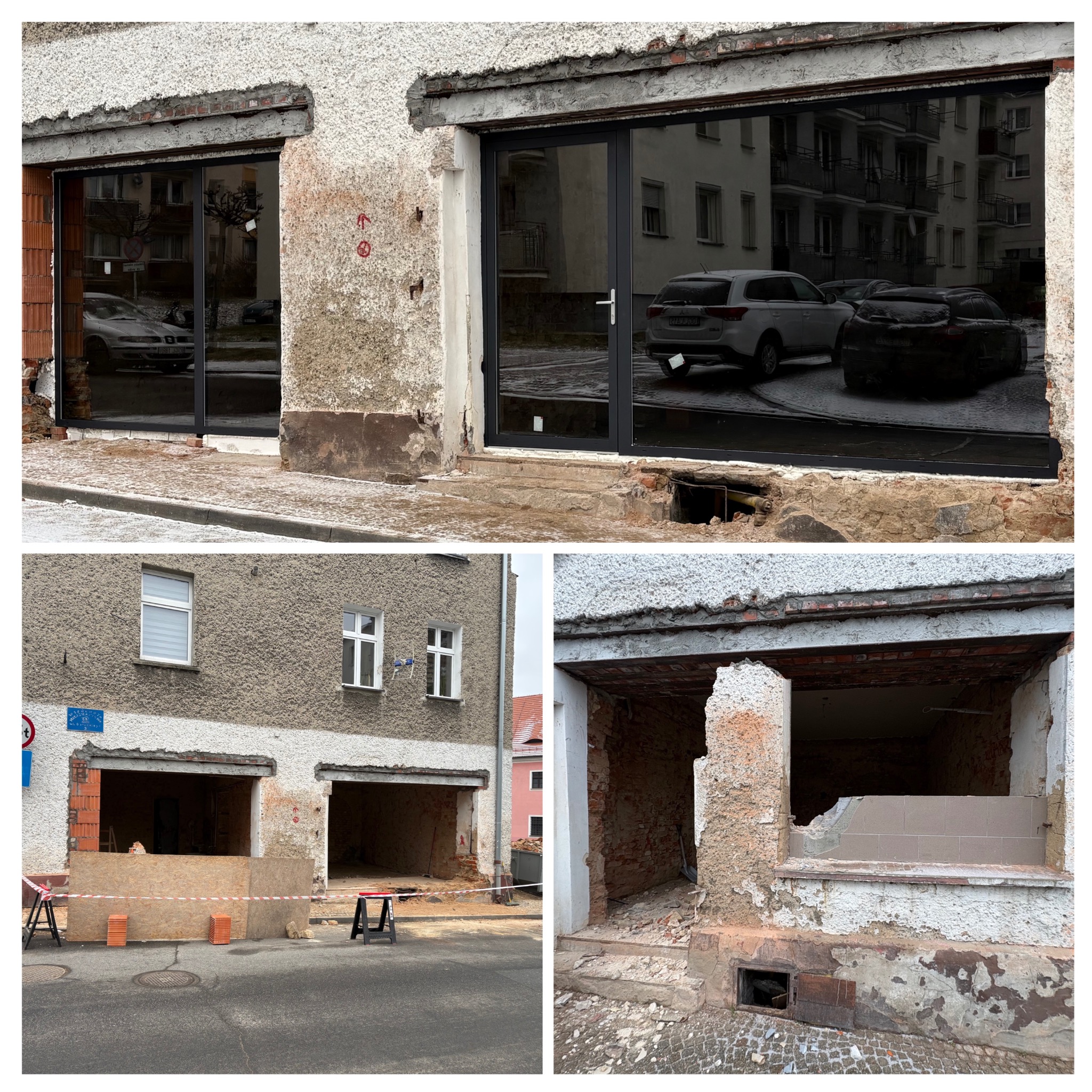 Montaż dużych, grafitowych okien w surowym otworze budynku. Widoczne ślady po kuciu i przygotowaniu do osadzenia. W oknach odbija się zabudowa miejska.