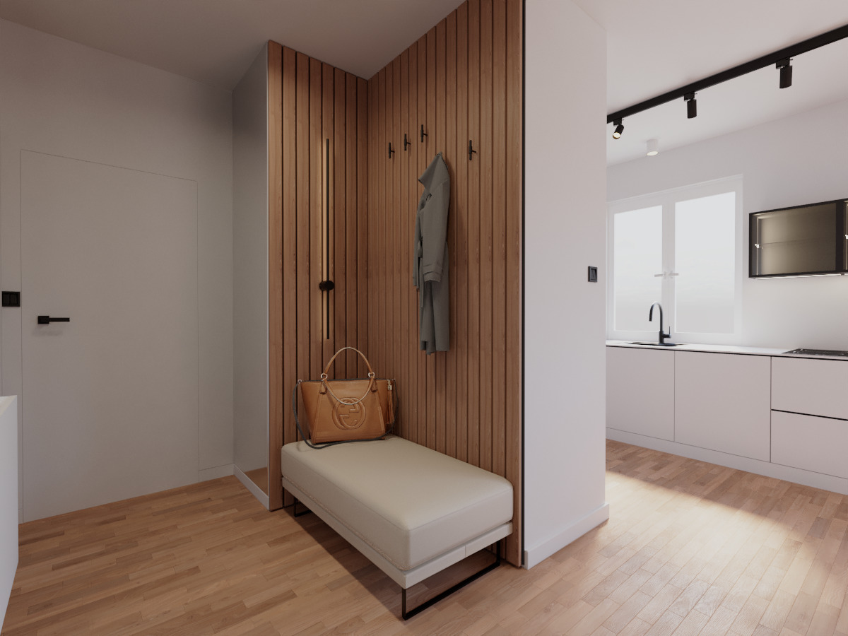 Wnętrze przedpokoju z drewnianą ścianą, wieszakami, ławką, torebką i widokiem na kuchnię w tle. Minimalistyczny design z ciepłym oświetleniem i parkietem.