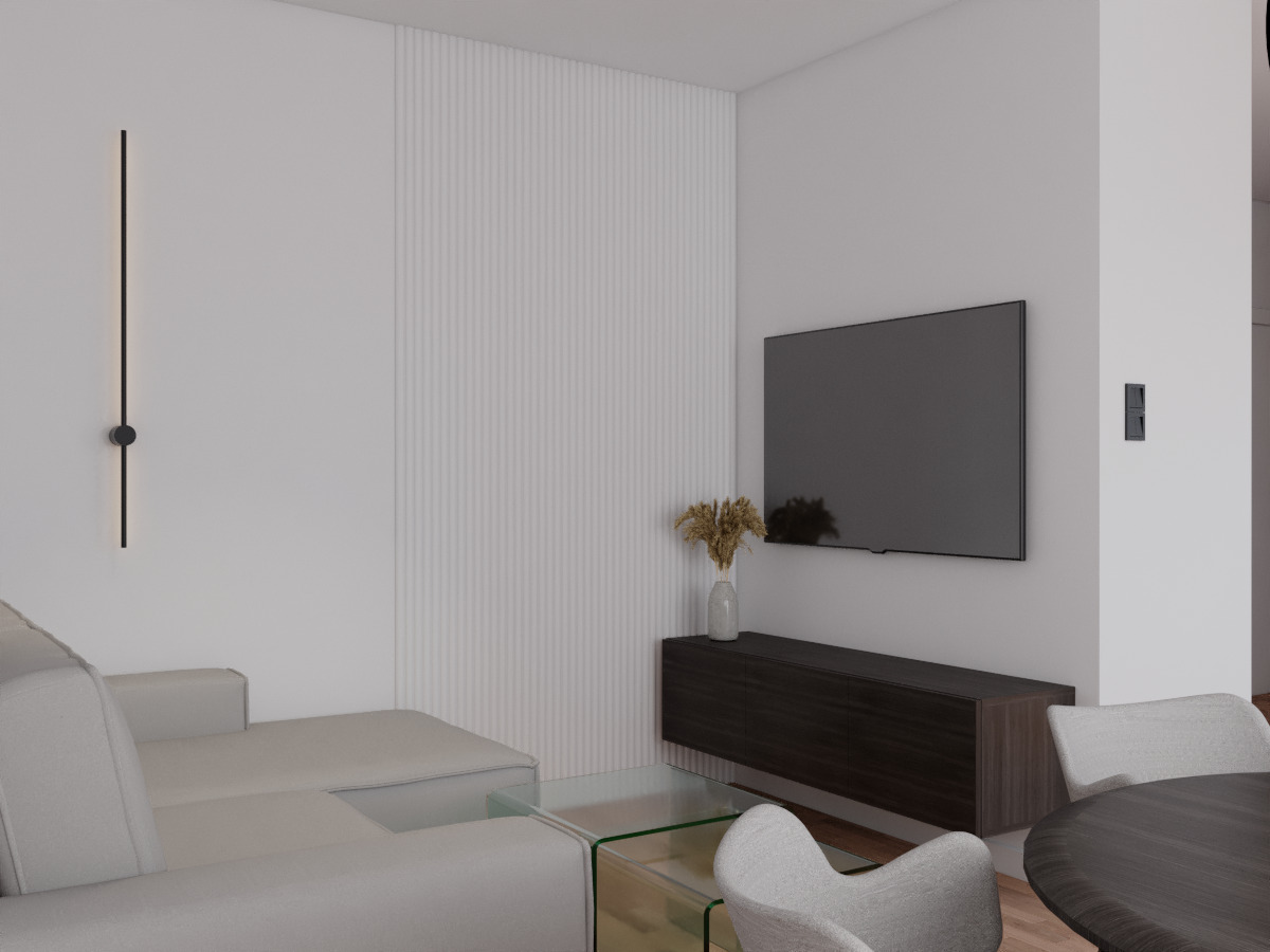 Minimalistyczny salon: szary narożnik, szklany stolik, ciemna szafka RTV, suszone kwiaty w wazonie, panel ścienny z pionowymi frezami i czarny kinkiet.