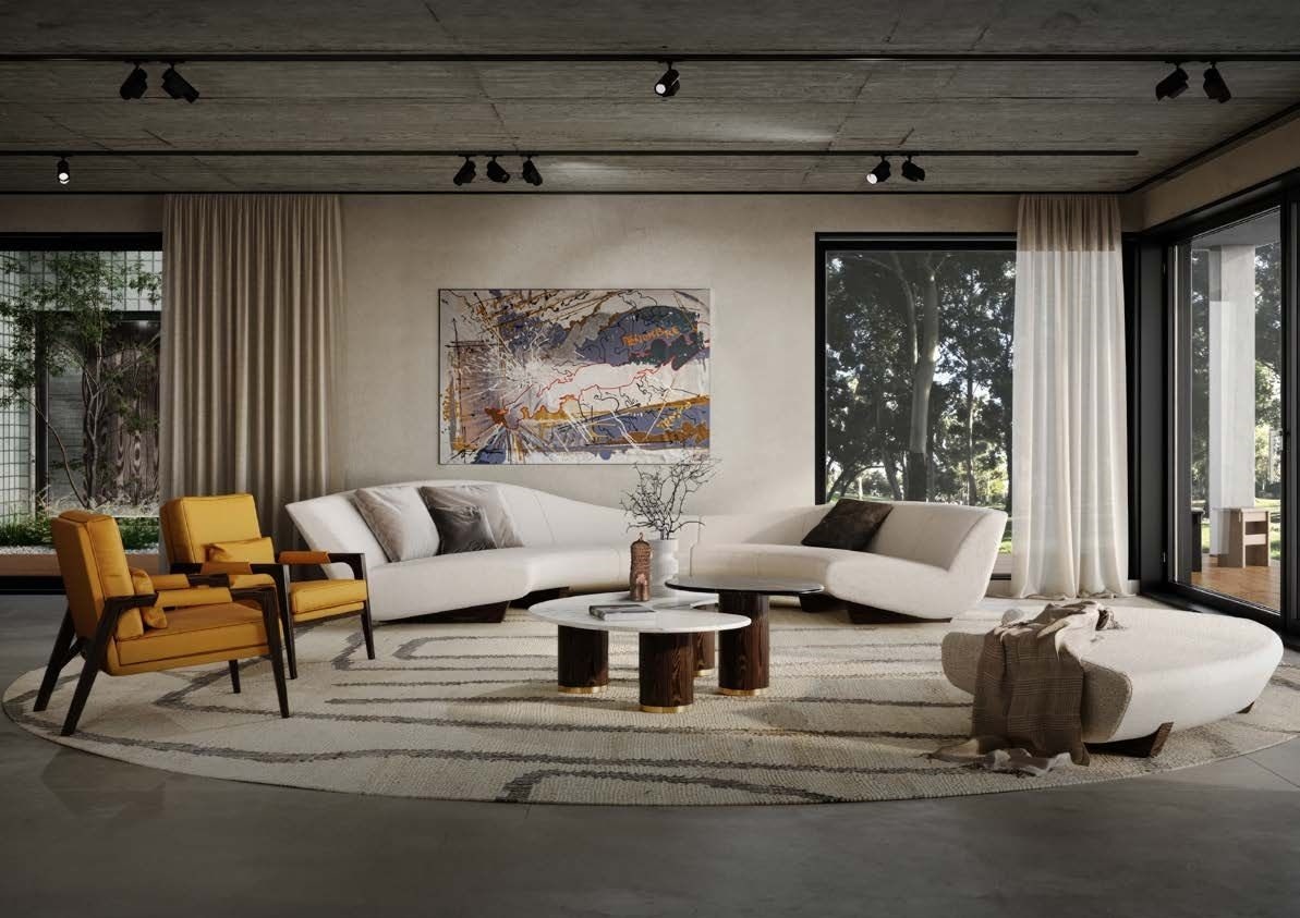 Elegancki salon z dwoma białymi sofami o obłych kształtach, żółtymi fotelami i okrągłym dywanem. Na ścianie abstrakcyjny obraz. Oświetlenie punktowe na betonowym suficie.