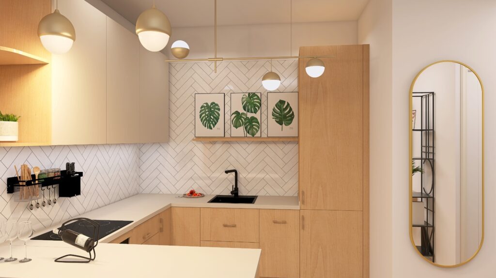 Jasna kuchnia z drewnianymi szafkami, białymi płytkami w jodełkę i złotymi lampami kulami. Na blacie wino i kieliszki, a na ścianie lustro w złotej ramie.