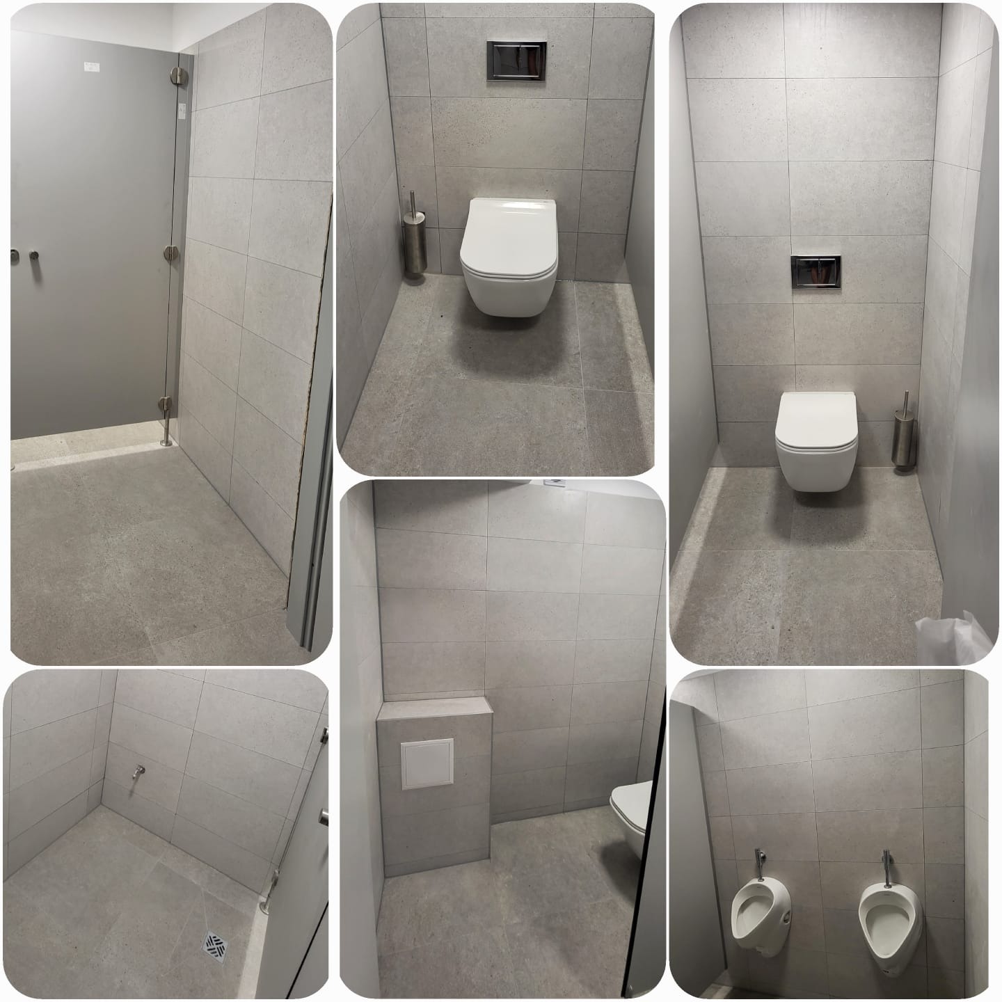 Nowoczesna toaleta publiczna z szarymi płytkami, wiszącymi muszlami klozetowymi i pisuarami. Minimalistyczny design z metalowymi akcentami i kabinami.