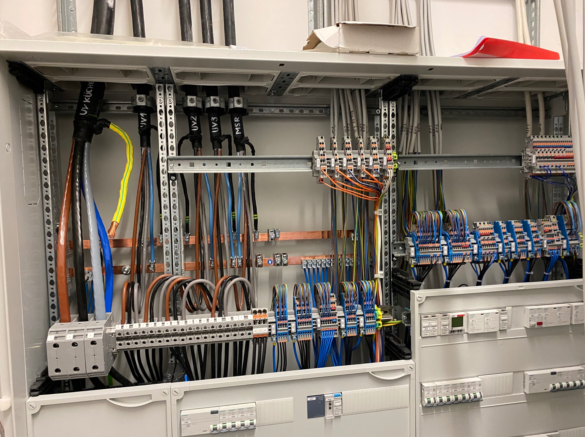 Rozdzielnia elektryczna z okablowaniem w szynie DIN, widok z bliska. Realizacja w Nowej Wsi, schludne ułożenie przewodów, oznaczenia UV i MSR.