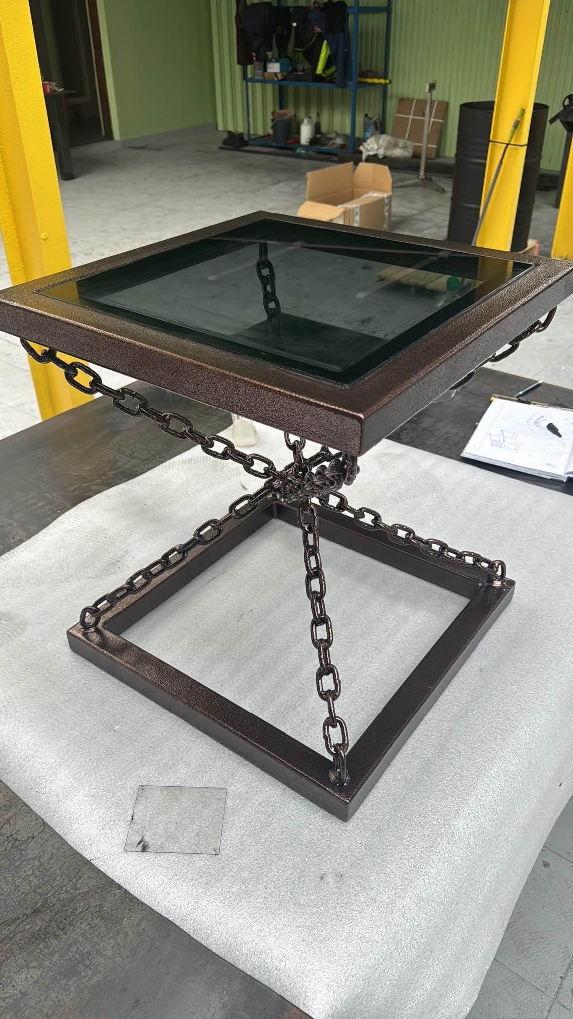 Metalowy stolik kawowy z szklanym blatem i łańcuchami w Tarnowie. Nietypowa konstrukcja spawana, nowoczesny design. Idealny do industrialnego wnętrza.