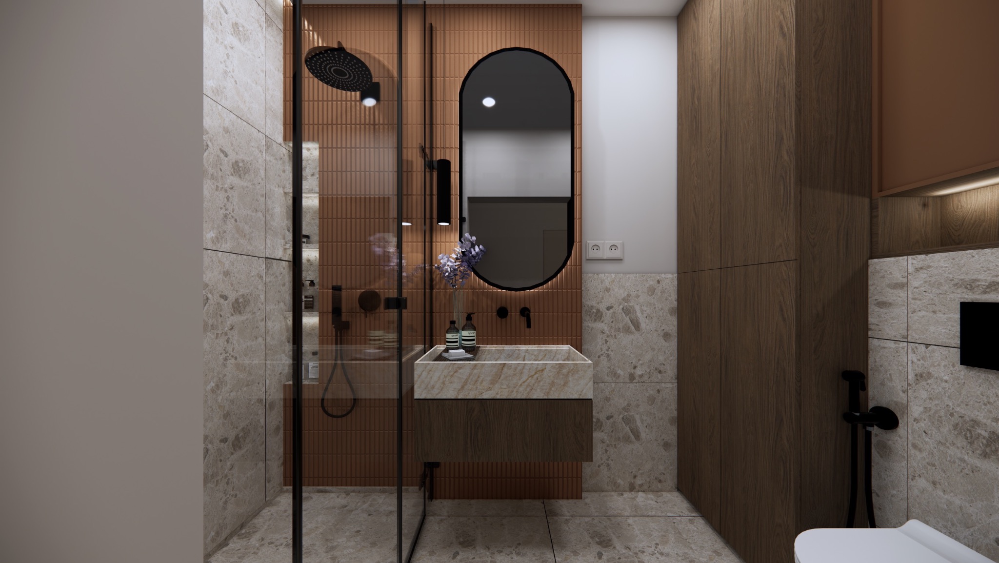 Nowoczesna łazienka z marmurowymi płytkami, kabiną prysznicową typu walk-in i umywalką z kamienia, oświetlona ledowym lustrem w kształcie elipsy.