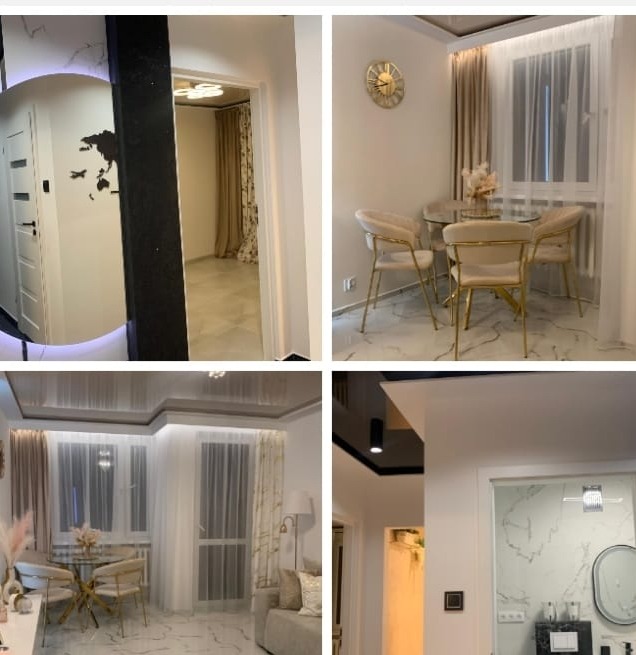 Eleganckie wnętrze: jadalnia z okrągłym stołem, salon z sofą i dekoracyjnym oświetleniem, marmurowe wykończenie ścian, nowoczesny design.