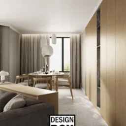 Stylowa aranżacja wnętrza z drewnianą zabudową, okrągłym stołem i nowoczesnymi lampami wiszącymi. Stonowana kolorystyka, minimalistyczny design, widok na zieleń za oknem.