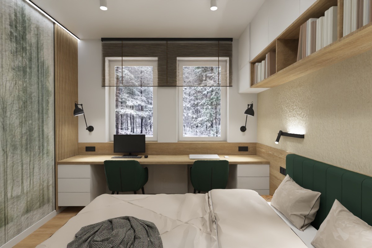 Wnętrze pokoju z miejscem do pracy i strefą relaksu w Łodzi. Dwa stanowiska z monitorami, zielone krzesła, drewniane półki, łóżko z zielonym zagłówkiem i widok na zimowy las.