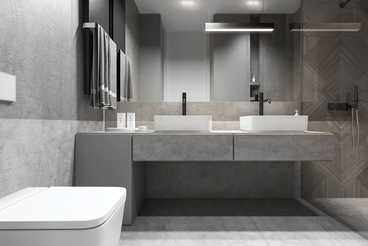 Nowoczesna łazienka w odcieniach szarości z dwiema umywalkami i geometrycznym wzorem na ścianie pod prysznicem. Minimalistyczny design z wiszącymi ręcznikami.