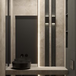 NEG DESIGN NATALIA GRZYWACZ - Nowoczesna łazienka z czarną umywalką nablatową i podświetlanymi panelami ściennymi z ciemnego drewna na tle marmurowej ściany.