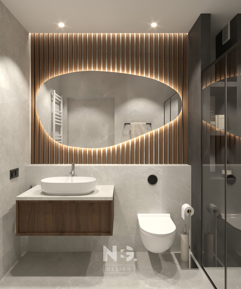 Nowoczesna łazienka z owalnym lustrem podświetlanym LED, drewnianymi lamelami i marmurowymi płytkami. Minimalistyczna umywalka nablatowa i szklana kabina prysznicowa.