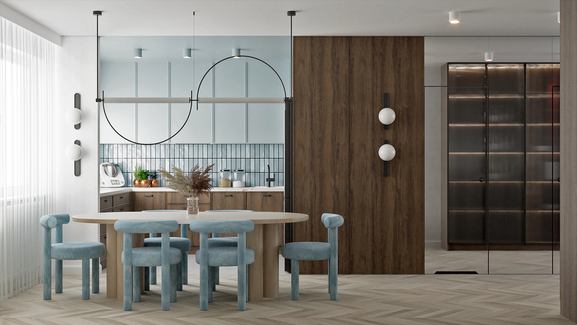 Pastelowa kuchnia z okrągłym stołem i błękitnymi krzesłami.  Minimalistyczne lampy i drewniane akcenty. Nowoczesny design z dbałością o detale i funkcjonalność.