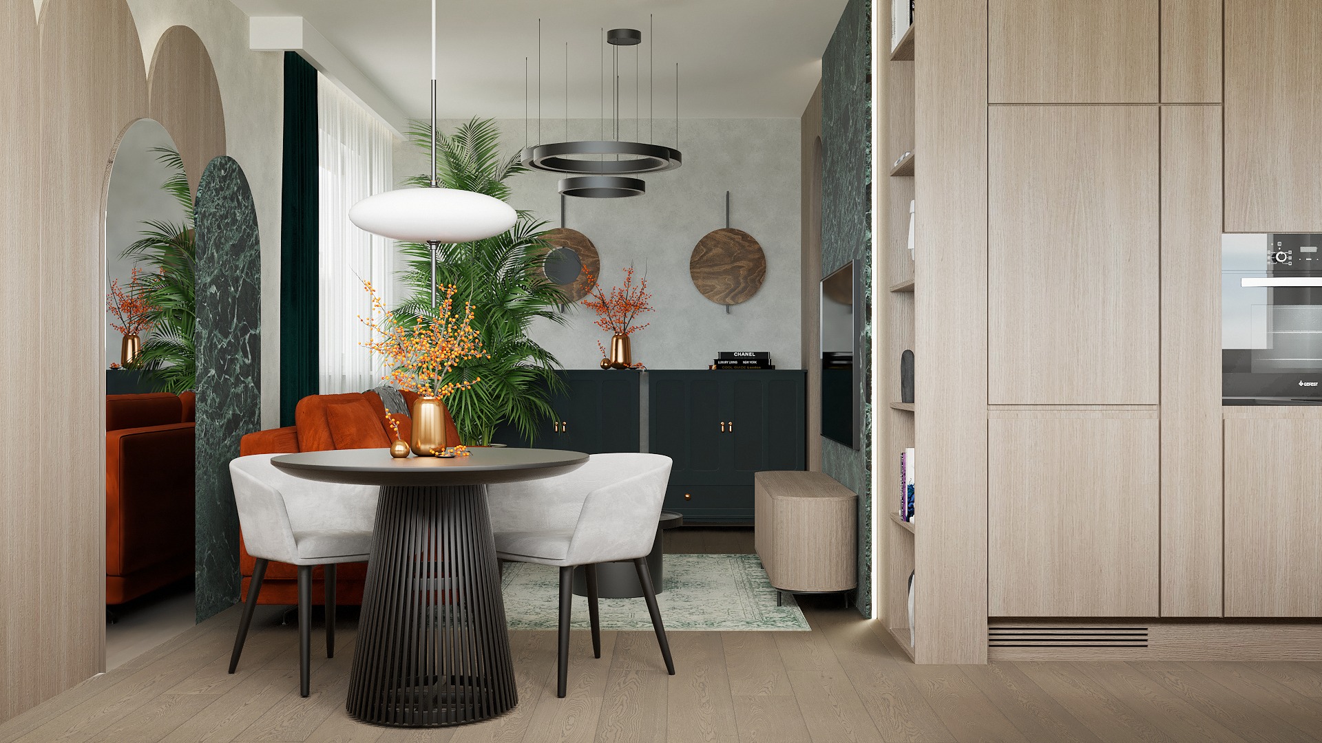 Stylowe wnętrze: okrągły stół z krzesłami, pomarańczowa sofa, zabudowa kuchenna z piekarnikiem i rośliny doniczkowe. Dekoracyjne oświetlenie i marmurowe akcenty.