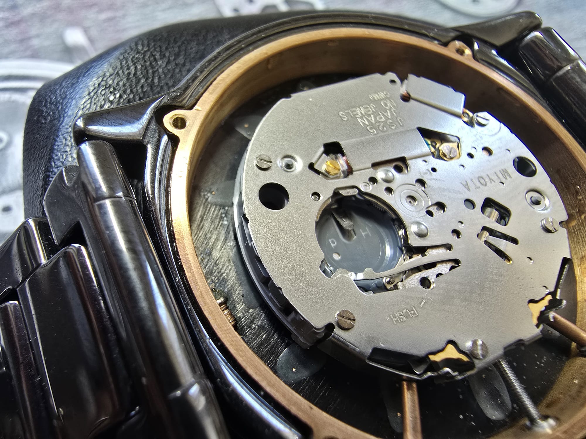 Otwarty zegarek z widocznym mechanizmem kwarcowym Miyota, detale precyzyjnej konstrukcji, śrubki i metalowe elementy. Zegarmistrzowska precyzja w zbliżeniu.