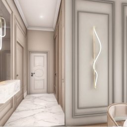 Arteriors - Elegancki korytarz z marmurową posadzką i subtelnym oświetleniem LED. Na ścianie dekoracyjne panele z minimalistyczną lampą. Lustro z podświetlaną konsolą.