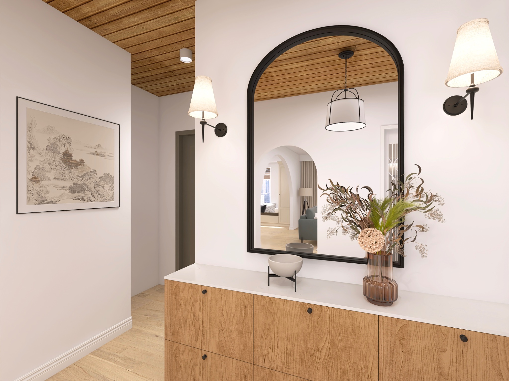 Nowoczesny przedpokój z drewnianą komodą, lustrem w czarnej ramie i dekoracyjnym bukietem. Oświetlenie stanowią kinkiety i wisząca lampa. Na ścianie obraz w czarnej ramie.