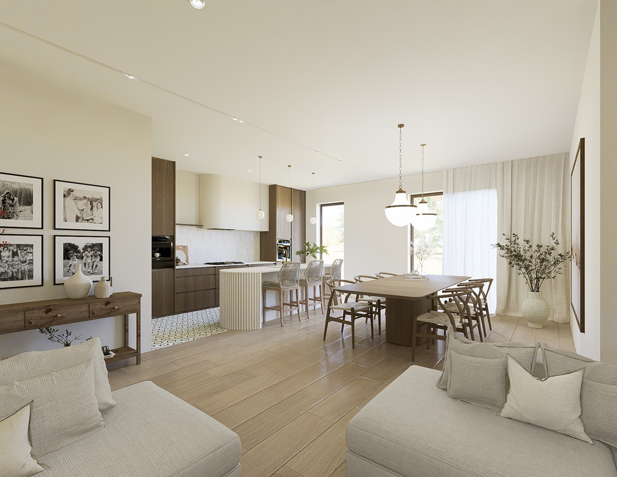 Jasne wnętrze domu: salon z sofą, jadalnia ze stołem i krzesłami oraz otwarta kuchnia z wyspą. Dekoracje: zdjęcia na ścianie, wazon z gałązkami i lampy wiszące.