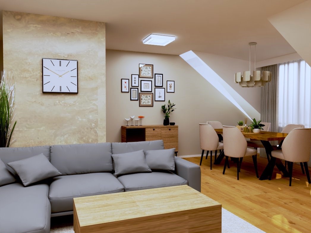 Jasne wnętrze z szarą sofą narożną, drewnianym stolikiem kawowym i stołem jadalnym z krzesłami. Na ścianie zegar i galeria ramek. Poddaszowy charakter.