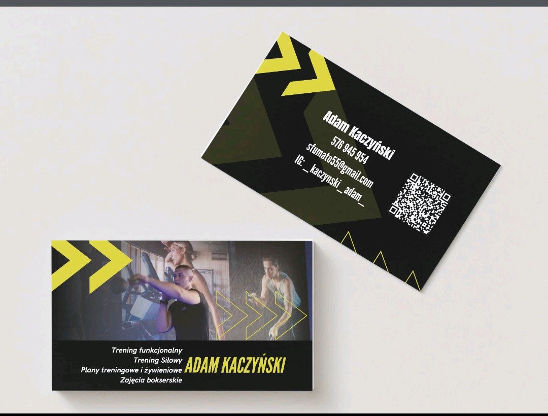 Wizytówki Adama Kaczyńskiego, trenera personalnego, z QR kodem, danymi kontaktowymi i zdjęciem z treningu siłowego. Czarno-żółta kolorystyka, nowoczesny design.