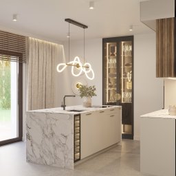 CM Studio - Nowoczesna kuchnia z wyspą o marmurowym wykończeniu, oświetleniem LED i przeszkloną witryną na naczynia. Minimalistyczny design z elementami dekoracyjnymi.