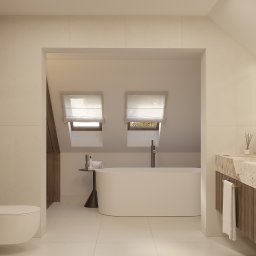 CM Studio - Jasna łazienka na poddaszu z wanną wolnostojącą, marmurową umywalką i toaletą. Okna dachowe z roletami wpuszczają naturalne światło. Minimalistyczny design.