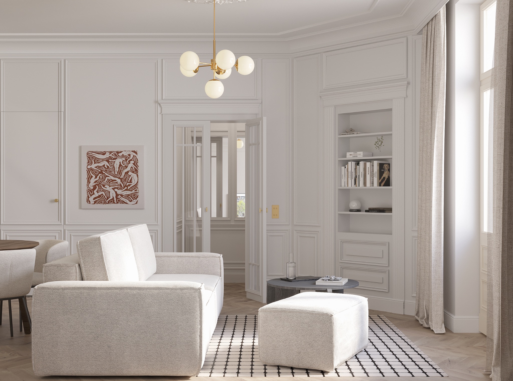 Jasne wnętrze salonu z sofą, pufą i okrągłym stolikiem kawowym. Na ścianie abstrakcyjny obraz i regał z książkami. Widoczny fragment jadalni.