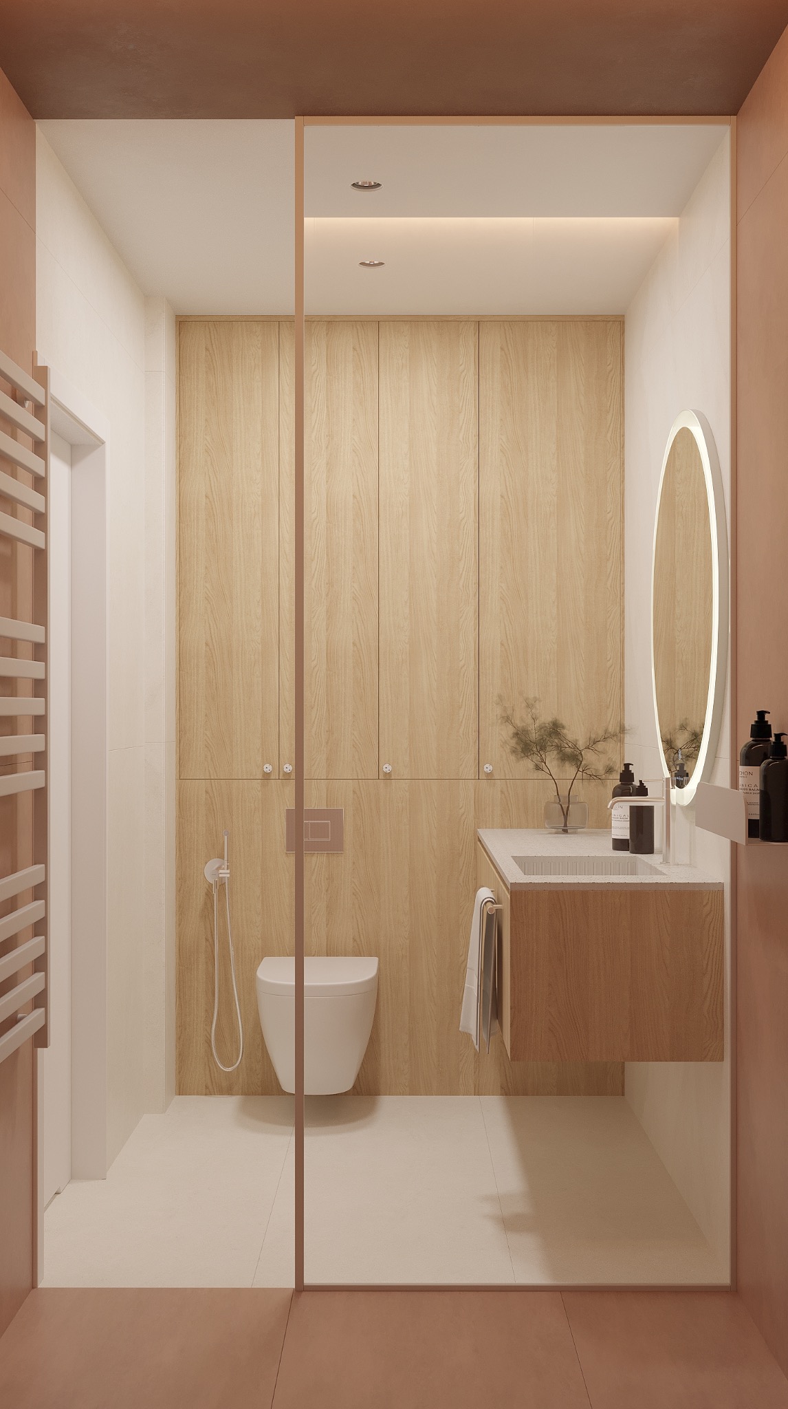 Nowoczesna łazienka w Toruniu z drewnianymi szafkami, owalnym lustrem z podświetleniem i minimalistyczną toaletą. Projekt w ciepłych, stonowanych barwach.