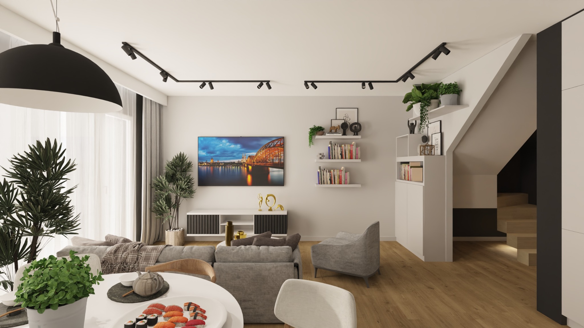 Jasne wnętrze salonu z drewnianą podłogą, szarą sofą i telewizorem na ścianie. Widoczne schody, oświetlenie szynowe i dekoracje roślinne nadają przytulny charakter.
