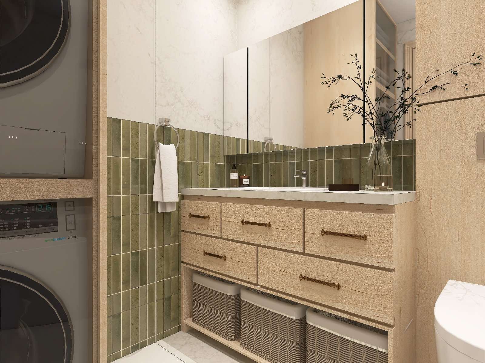 Nowoczesna łazienka z umywalką w zabudowie z drewnianymi szufladami i koszami, zielone płytki na ścianie, pralka obok. Minimalistyczny styl z roślinnym akcentem na blacie.