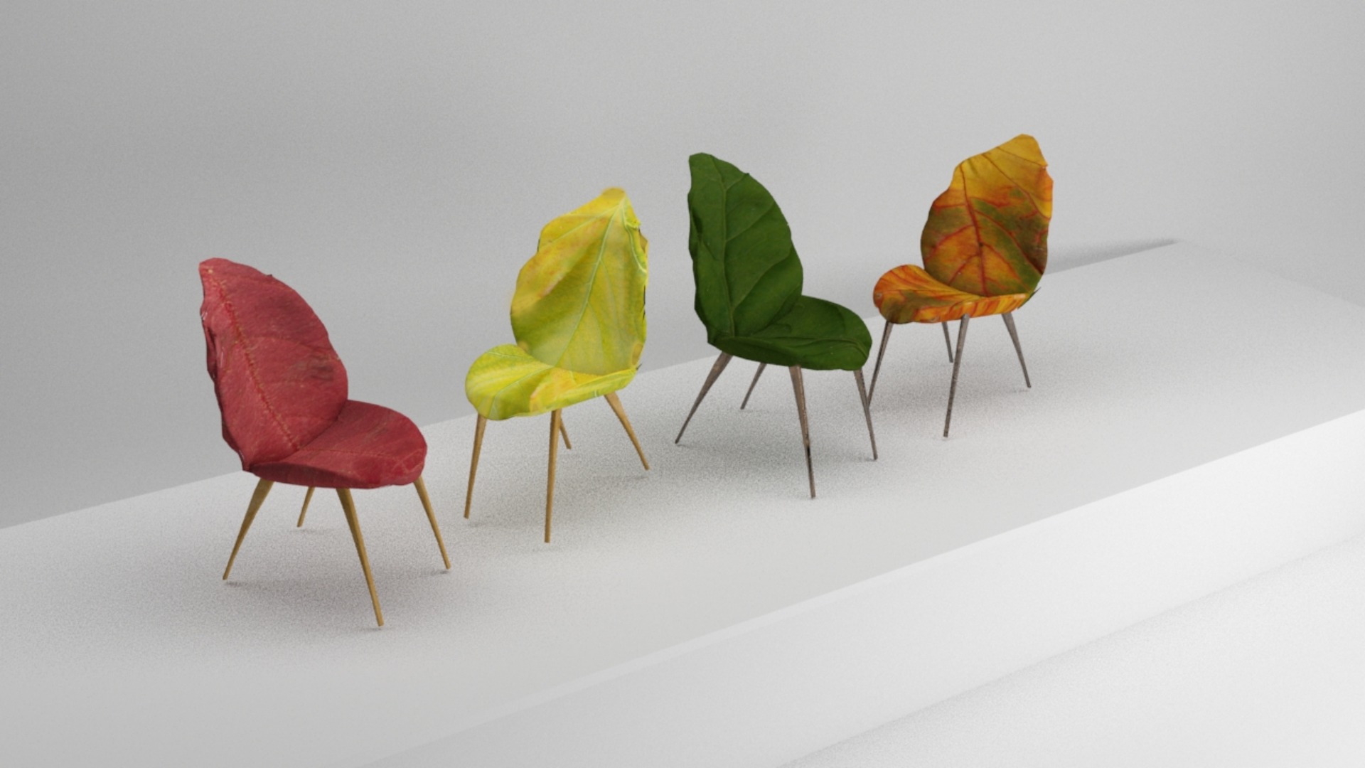 Cztery krzesła w kształcie liści, każde w innym kolorze jesieni: czerwonym, żółtym, zielonym i pomarańczowym, ustawione na białym podeście, minimalistyczne ujęcie.