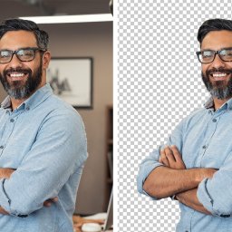 Grafmaga - Portret uśmiechniętego mężczyzny w okularach i błękitnej koszuli na tle biura, z wersją z przezroczystym tłem po prawej stronie.
