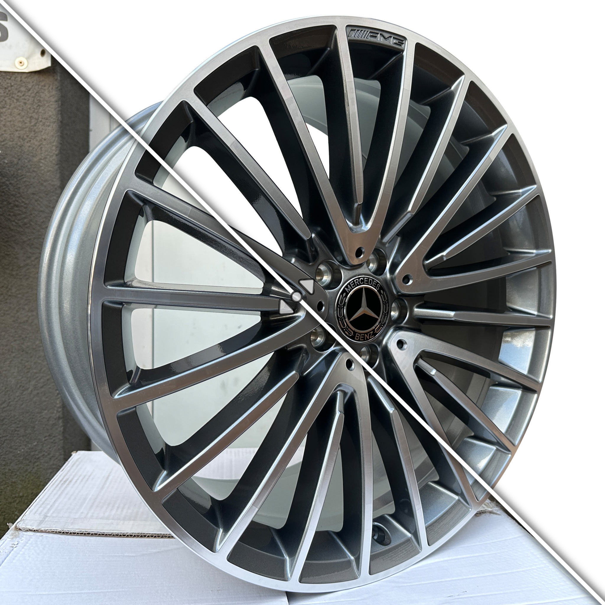 Felga aluminiowa Mercedes-Benz AMG z 20 ramionami w kolorze srebrno-czarnym, na białym tle, z widocznym logo producenta na środku. Detaliczne ujęcie.