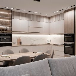 DZ Interiors - Nowoczesna kuchnia w beżach i drewnie: minimalistyczne szafki, oświetlenie LED, stół z krzesłami i fragment sofy. Elegancki design wnętrza z wbudowanym sprzętem Miele.