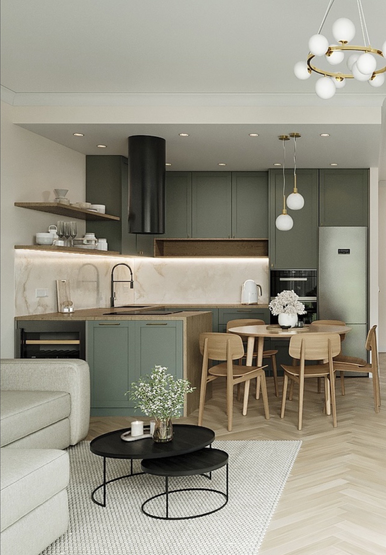 Nowoczesna kuchnia w odcieniach zieleni z drewnianymi krzesłami i okrągłym stołem. Nad stołem wiszą dwie lampy. Na blacie kwiaty w wazonie.